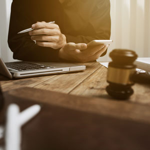 Focused attorney analyzing documents, dedicated to providing strong advocacy and representation.