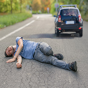 Injured pedestrian on a road following a Los Angeles hit-and-run incident with a fleeing vehicle.